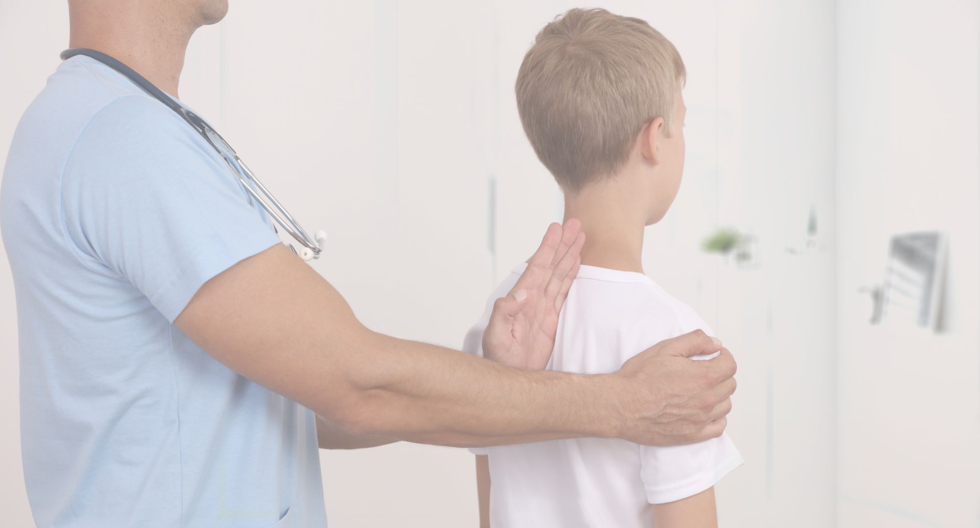 Doctor holding his hand on child's spine